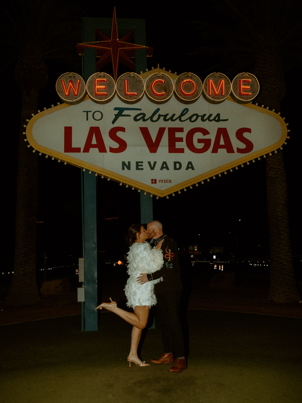 couple eloping in front of the las vegas sign
